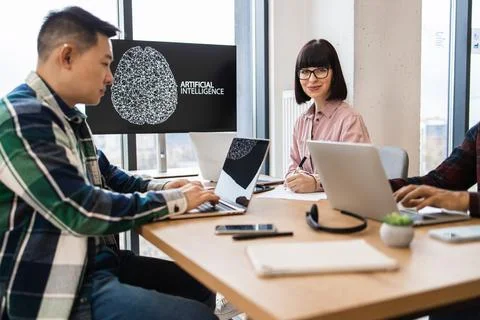 IT experts working on artificial intelligence development in modern office Stock Photos