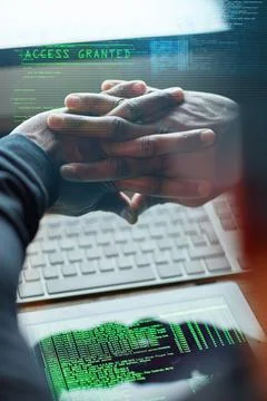 It feels so good to be bad. Cropped shot of an unidentifiable hacker cracking Stock Photos