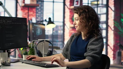IT female technician uses coding language on computer at the agency Stock Footage 308604318