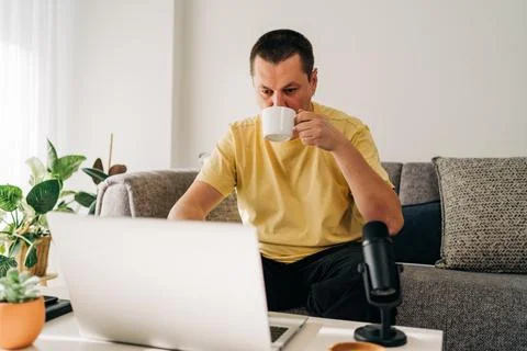 IT freelancer men with microphone typing in laptop working from home office Stock Photos
