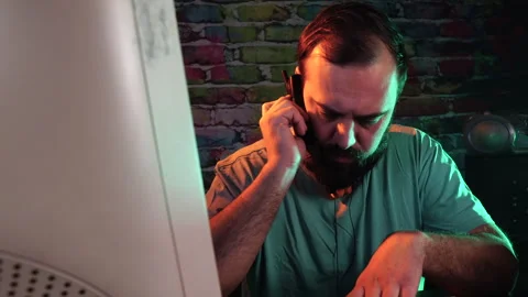 IT Guy From 1990's Answering Phone Call on Old Cellphone in Front of Computer Stock Footage 302473401