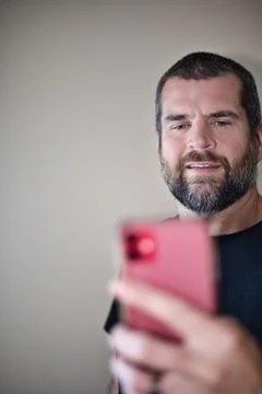 IT Guy Looking at Cell Phone Stock Photos