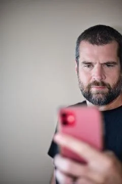 IT Guy Looking at Cell Phone - Serious Foto stock