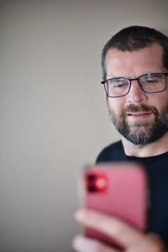 IT Guy Looking at Cell Phone Stock Photos