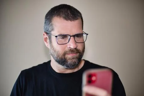 IT Guy Looking at Cell Phone Stock Photos
