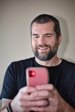 IT Guy Looking at Cell Phone Stock Photos