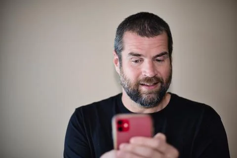IT Guy on Smartphone Entertained Stock Photos