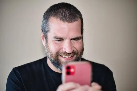 IT Guy on Smartphone Smiling Stock Photos
