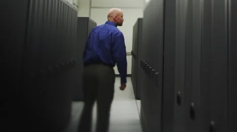 IT Guy Walks Through Servers Stock Footage 62903374