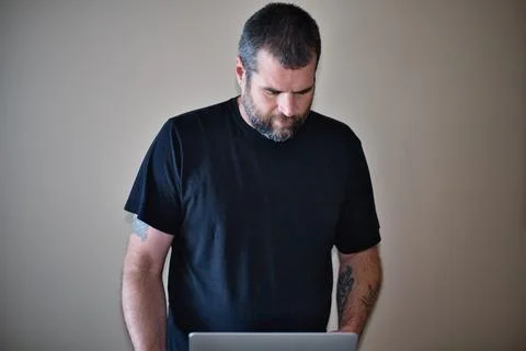 IT Guy Working On Location - Troubleshooting the Issue While Standing 写真素材