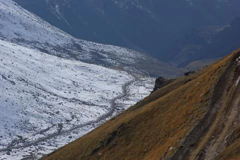 It has snowed on the mountains. The forest is covered with snow. Stock Photos