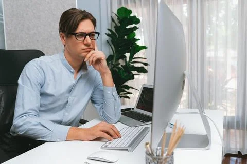 IT looking at online software development on pc align working laptop. Pecuniary. 库存照片