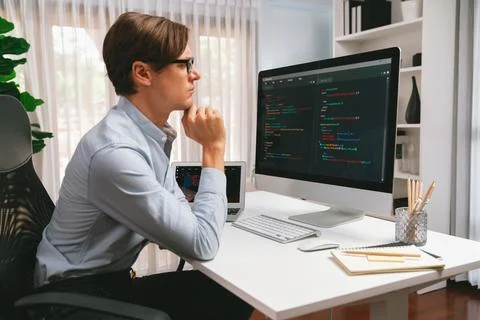 IT looking at online software development on pc align working laptop. Pecuniary. Stock Photos