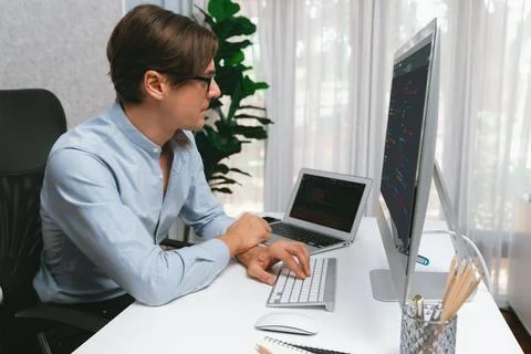 IT looking at online software development on pc align working laptop. Pecuniary. Stockfoto's