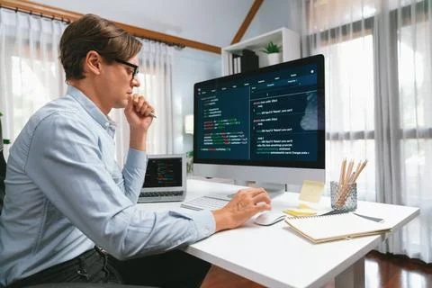 IT looking at online software development on pc align working laptop. Pecuniary. Foto stock