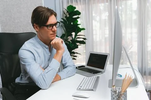 IT looking at online software development on pc align working laptop. Pecuniary. Stockfoto's