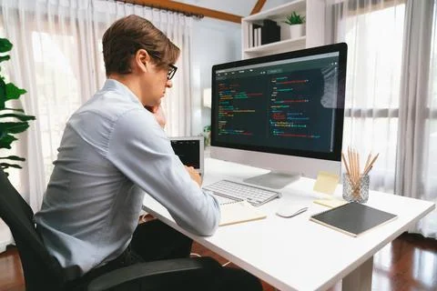 IT looking at online software development on pc align working laptop. Pecuniary. Foto stock