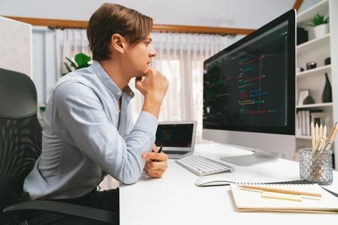 IT looking at online software development on pc align working laptop. Pecuniary. Stockfoto's