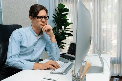 IT looking at online software development on pc align working laptop. Pecuniary. Stock-Fotos