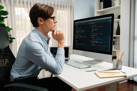 IT looking at online software development on pc align working laptop. Pecuniary. 스톡 사진