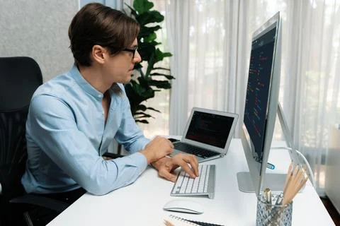 IT looking at online software development on pc align working laptop. Pecuniary. 스톡 사진