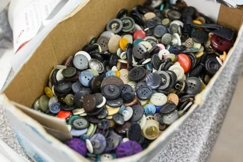It is a lot of buttons in a box. a workshop on tailoring of theatrical suits Stock Photos