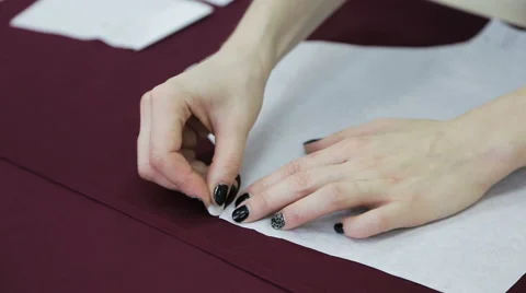 It makes sewing a pattern. painting on fabric. preparation for sewing Stock Footage 60761930