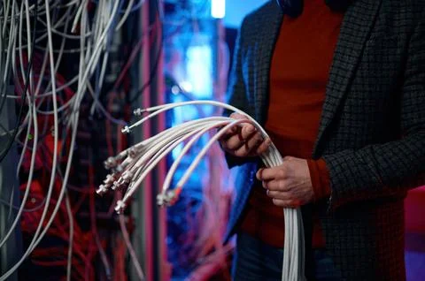 IT man with bunch of cables in hands in server room Stock Photos