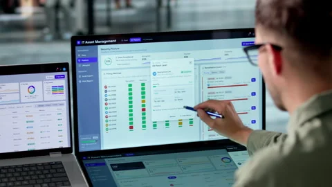 IT Manager Reviews Asset Inventory On Laptop Stock Footage 340398703