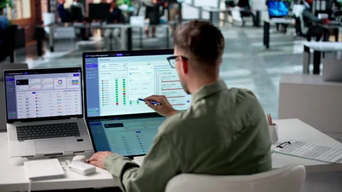IT Manager Reviews Asset Inventory On Laptop Stock Footage 340996949