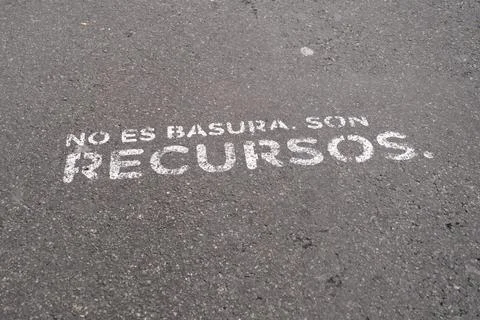 It is not garbage, it is resources. Recycling message painted on the asphalt. Stock-Fotos