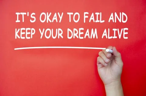 It is okay to fail and keep your dream alive text written on red cover back.. Foto stock