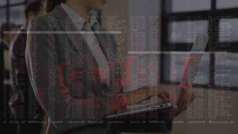 IT pro coding on laptop starting red glow, code overlay streaming on screen as Stock Footage 312695103