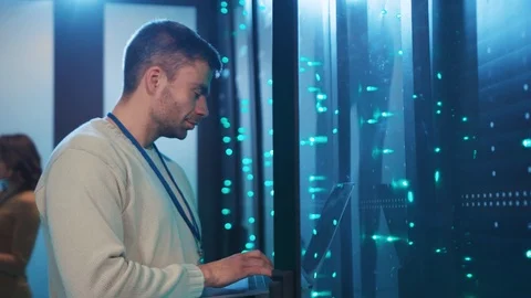 IT professional checking open server rack updating hardware or doing backup Stock Footage 120263921