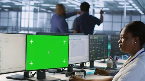 IT professional coding on chroma key PC in data center Stock Photos