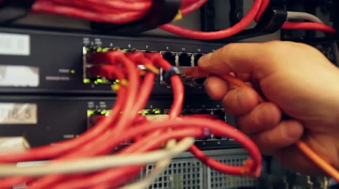 IT professional connecting network cable in datacenter Stock Footage 53063901