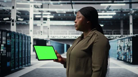 IT professional in data center using green screen tablet Stock Footage 317202464
