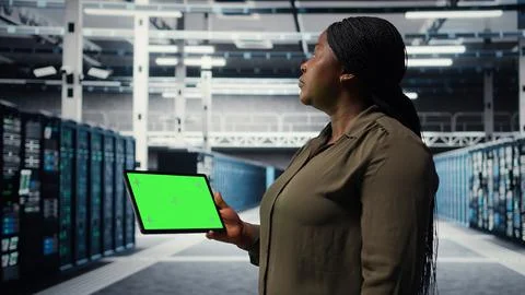 IT professional in data center using green screen tablet 스톡 사진