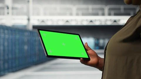 IT professional in data center using green screen tablet 스톡 사진