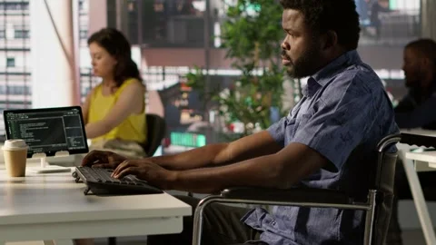 IT professional with disability in wheelchair optimizing code Stock Footage 318162640