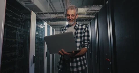 IT Professional Holding Laptop in Server Room Stock Footage 276554081