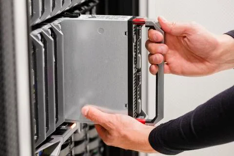 IT professional installs server cluster in large datacenter Stock Photos