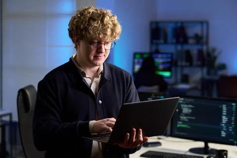 IT Professional Programming on Laptop in Cybersecurity Office Stock Photos