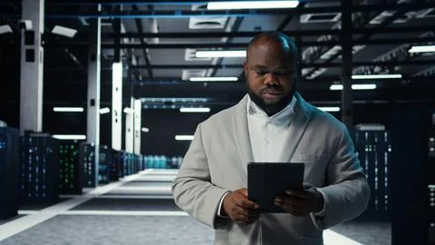 IT professional in server hub ensures data remains shielded from threats 스톡 사진