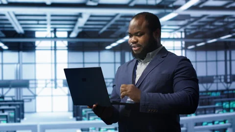 IT professional in server room looking for network issues Stock Footage 277646831