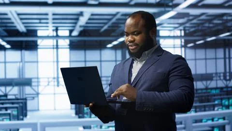 IT professional in server room looking for network issues Stock Photos