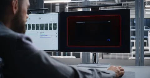 IT Professional Troubleshooting Critical System Error in Large Data Center Stock Photos