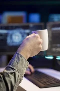 IT professional upgrading high tech AI, drinking coffee, close up 스톡 사진