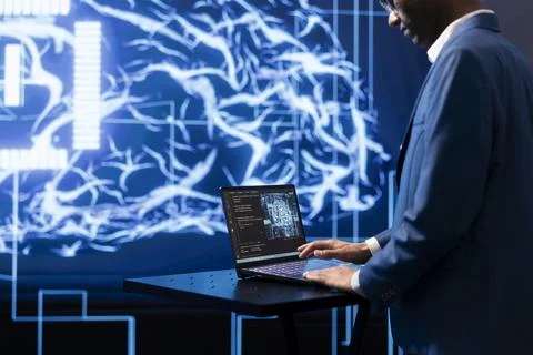 IT professional working on notebook to automatize AI tasks Stock Photos