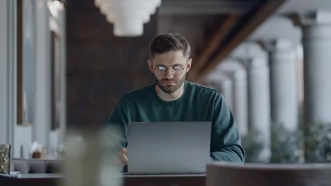 IT Professional Working Remotely With Laptop In Restaurant In Daytime Stock-Footage 343410485
